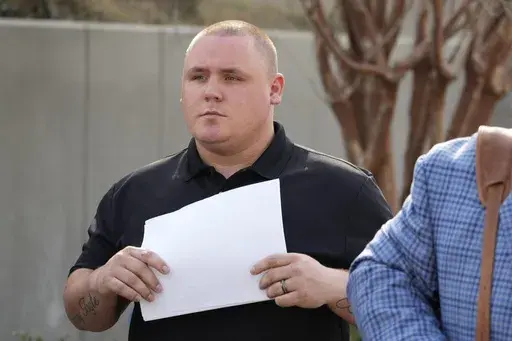 Former City of Pearl, Miss., police Officer Michael Christian Green walks out of the federal courthouse in Jackson, Miss., Thursday, March 14, 2024, after pleading guilty to a federal misdemeanor charge after authorities said he forced a man he had arrested to lick urine off the floor of a jail cell. (AP Photo/Rogelio V. Solis)