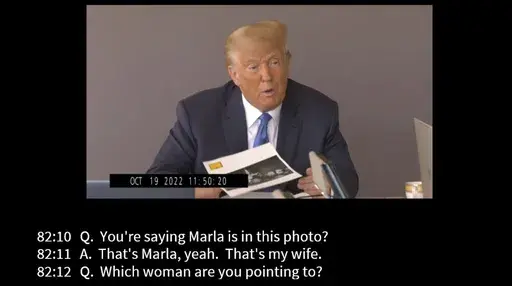 In this image taken from video released by Kaplan Hecker & Fink, former President Donald holds a photograph, presented as evidence during his Oct. 19, 2022 deposition, that shows E. Jean Carroll and her then-husband John Johnson meeting Trump and his wife Ivanka at an event in the 1980s. In his deposition, Trump mistook Carroll as Marla Maples, his now ex-wife, when shown the image. The video recording of Trump being questioned about the rape allegations against him was made public for the first
