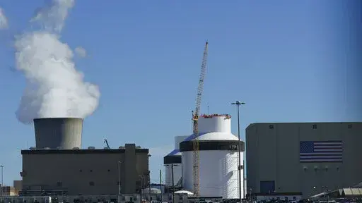Reactor number 3 and it's cooling tower stands at Georgia Power Co.'s Plant Vogtle nuclear power plant on Jan. 20, 2023, in Waynesboro, Ga. The nuclear plant has begun splitting atoms in one of its two new reactors, Georgia Power Co. said Monday, March 6, 2023, a key step toward reaching commercial operation at the first new nuclear reactors built from scratch in decades in the United States. (AP Photo/John Bazemore, File)