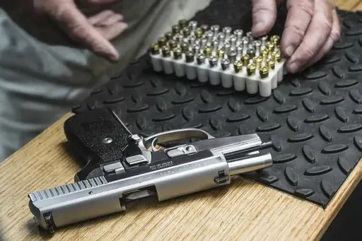 The owner of a shooting range, prepares to load bullets in his 9mm semi-automatic handgun for a demonstration, Thursday, June 23, 2022, in New York. A government study released on Thursday, March 30, 2023, highlights just how violent America's recent past has been by showing a surge in gunfire injuries during the COVID-19 pandemic, when the number ofpeople fatally shooting each other— and themselves -- also increased. (AP Photo/Bebeto Matthews, File)