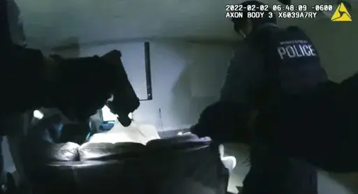 In this image taken from Minneapolis Police Department body camera video and released by the city of Minneapolis, Minneapolis police enter an apartment on Wednesday, Feb. 2, 2022, moments before shooting 22-year-old Amir Locke. Minneapolis Mayor Jacob Frey has imposed a moratorium on no-knock warrants after Locke was killed as a SWAT team carried out a search warrant in a downtown apartment. (Minneapolis Police Department via AP)