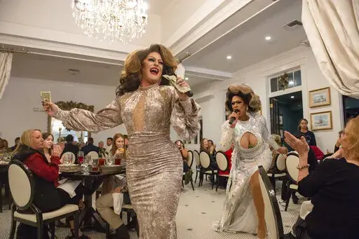 Drag queens Ivy Dripp and Lexis Redd D'ville open drag brunch at White Pillars in Gulfport, Miss., on Sunday, Dec. 19, 2021. Nearly everyone involved in the always-sold-out monthly drag brunches at White Pillars agree the set-up seems improbable. This is the Deep South, and White Pillars has been “an icon” on the Coast for so long. (Hannah Ruhoff/The Sun Herald via AP)