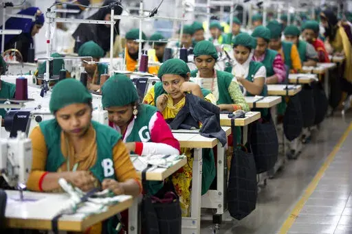 Trainees work at Snowtex garment factory in Dhamrai, near Dhaka, Bangladesh, April 19, 2018. Bangladesh's economic miracle is under severe strain as fuel price hikes amplify public frustrations over rising costs for food and other necessities. (AP Photo/A.M. Ahad, File)