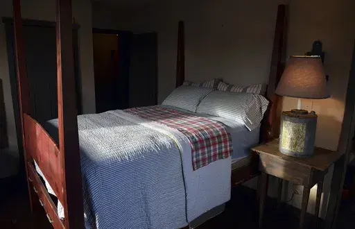 This Nov. 11, 2013 file photo shows a bedroom built by Mike Spangler using some reclaimed materials, in Belle, W.Va. Nearly one-third of American adults don't get the recommended seven to nine hours of sleep per night. Some of the major causes: Stress, anxiety and a culture that experts say is about productivity, not rest. (Craig Cunningham/Charleston Daily Mail via AP, file)