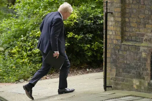 Britain's Prime Minister Bortis Johnson walks in Downing Street to a press conference in London, Wednesday, May 25, 2022.A report into lockdown-breaching U.K. government parties says blame for a "culture" of rule-breaking in Prime Minister Boris Johnson's office must rest with those at the top. Senior civil servant Sue Gray's long-awaited report was published Wednesday.(AP Photo/Kirsty Wigglesworth)