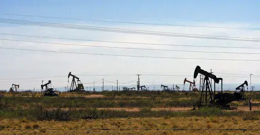 Oil rigs stand in the Loco Hills field along U.S. Highway 82 in Eddy County, near Artesia, N.M., one of the most active regions of the Permian Basin. Government budgets are booming in New Mexico. The reason behind the spending spree — oil. New Mexico is the No. 2 crude oil producer among U.S. states and the top recipient of U.S. disbursements for fossil fuel production on federal land. But a budget flush with petroleum cash has a side effect: It also puts the spotlight on how difficult it is f