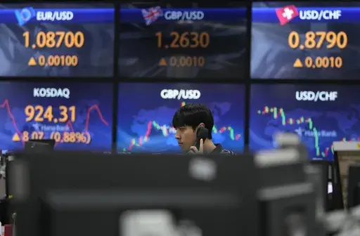 A currency trader talks on the phone at the foreign exchange dealing room of the KEB Hana Bank headquarters in Seoul, South Korea, Wednesday, Aug. 30, 2023. Asian shares rose Wednesday, boosted by a Wall Street rally that came on positive reports on consumer confidence and job openings.(AP Photo/Ahn Young-joon)