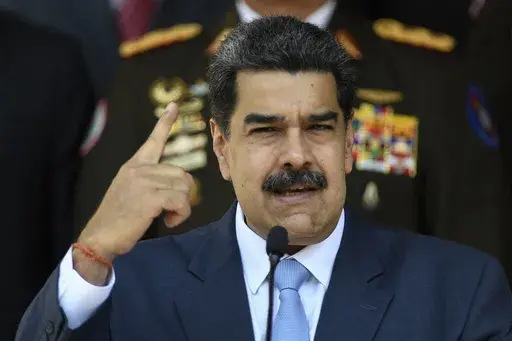 In this March 12, 2020 file photo, Venezuelan President Nicolas Maduro gives a press conference at the Miraflores presidential palace in Caracas, Venezuela. Jordan Goudreau, a former U.S. Green Beret who organized a failed crossborder raid in 2020 to remove President Maduro has been arrested in New York. (AP Photo/Matias Delacroix, File)