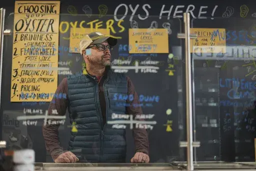Bryan Szeliga owner of Fishtown Seafood poses for a photograph at his location in Haddonfield, N.J., Thursday, March 6, 2025. (AP Photo/Matt Rourke)