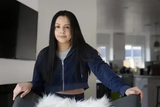 Cassandra Nuñez poses for a portrait at home Thursday, May 11, 2023, in Inglewood, Calif. Nuñez and her grandmother cast their first ballots in a U.S. presidential election in 2016. She was a first-year college student; her grandmother, a newly minted citizen. (AP Photo/Marcio Jose Sanchez)