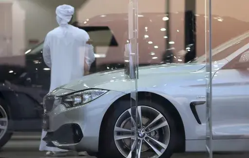 A man visits a car showroom in Dubai, United Arab Emirates, Thursday, June 2, 2016. A popular online influencer has been arrested in Dubai over a satirical TikTok video in which he portrays a brash Emirati on a spending spree inside a luxury car showroom. (AP Photo/Kamran Jebreili, File)