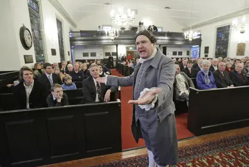 Virginia Gov-elect, Terry McAuliffe, seated center, listens as historical interpreter, Michael Wells, center, re-enacts the speech of Patrick Henry in St. John's church on church Hill in Richmond, Va., Friday, Jan. 10, 2014. McAuliffe is due to be inaugurated as the 72nd Governor of Virginia. (AP Photo/Steve Helber, File)