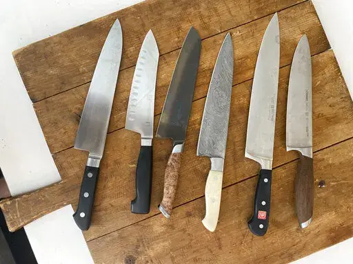 This July 2022 image shows a variety of kitchen knives. Many professionals will say you can perform virtually any kitchen task skillfully with either a chef’s knife or a paring knife. Adding other knives to your arsenal is appealing and can be useful but isn't strictly necessary. (Katie Workman via AP)