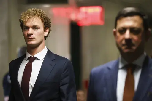 Daniel Penny, left, walks towards the courtroom, Friday, Dec. 6, 2024, in New York. (AP Photo/Heather Khalifa)