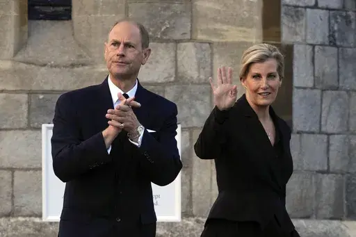 Britain's Prince Edward and Sophie, Countess of Wessex, wave to mourners outside the Windsor Castle in Windsor, England, on Sept. 16, 2022. Britain’s King Charles III has made his youngest brother the Duke of Edinburgh, passing on a title held by their late father, Prince Philip. Buckingham Palace said the title was conferred on Prince Edward on Friday, March 10, 2023, his 59th birthday. (AP Photo/Kin Cheung, File)