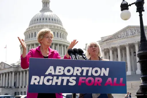 Sen. Elizabeth Warren, D-Mass., and Sen. Patty Murray, D-Wash., talk to reporters as the Supreme Court is poised to possibly overturn Roe v. Wade, at the Capitol in Washington, June 15, 2022.  The Democratic National Committee is launching a digital ad campaign to energize its voters after last month’s Supreme Court decision overturning Roe v. Wade. The ad campaign warns that Republicans’ ultimate goal is to outlaw abortion nationwide.  (AP Photo/J. Scott Applewhite, File)