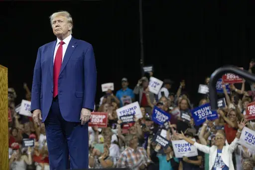 Former President Donald Trump stands as the crowd cheers at the South Dakota Republican Party Monumental Leaders rally Friday, Sept. 8, 2023, in Rapid City, S.D. (AP Photo/Toby Brusseau)