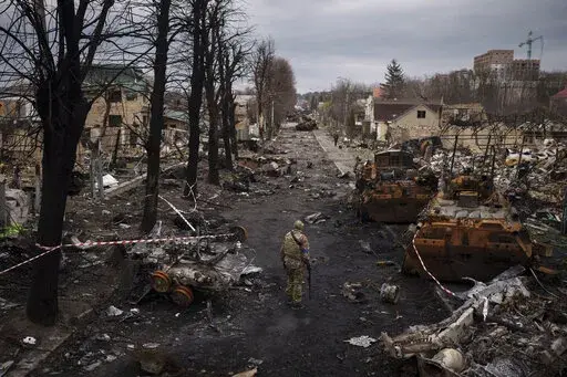 A Ukrainian serviceman walks amid destroyed Russian tanks in Bucha, on the outskirts of Kyiv, Ukraine, April 6, 2022. Russia is bracing up for a massive new offensive in eastern Ukraine, hoping to reverse its fortunes on the battlefield after a catastrophic start of the invasion. (AP Photo/Felipe Dana, File)