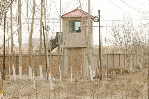 A security guard watches from a tower around a detention facility in Yarkent County in northwestern China's Xinjiang Uyghur Autonomous Region on March 21, 2021. As world leaders gather in New York at the annual U.N. General Assembly, rising superpower China is also focusing on another United Nations body that is meeting across the Atlantic Ocean in Geneva.  (AP Photo/Ng Han Guan, File)