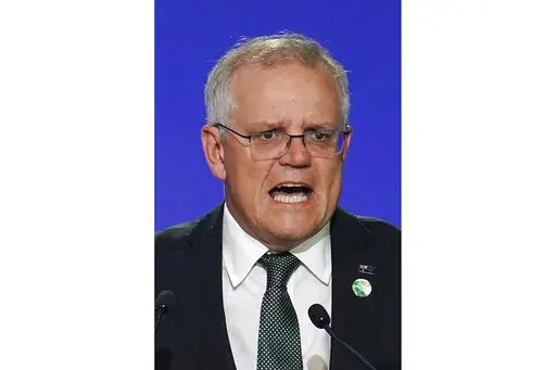 Australia's Prime Minister Scott Morrison delivers an address, during the COP26 Summit, at the SECC in Glasgow, Scotland, Monday, Nov. 1, 2021. In at least one sense, Morrison is the most successful Australian prime minister in years. He is the first to survive in office from one election to the next since 2007. That year, the government of Australia's second-longest-serving Prime Minister John Howard was voted out after a reign of almost 12 years. (Ian Forsyth/Pool Photo via AP, File)