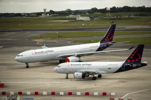 In this Tuesday, May 12, 2020 file photo, planes from Brussels Airlines on the tarmac at Brussels Airport in Brussels Tuesday, May 12, 2020. The European Union's airspace is filling up again with near-empty flights in pandemic times that even airlines admit serve no commercial purpose except securing valuable slots in some of the world's biggest airports. (AP Photo/Francisco Seco, File)