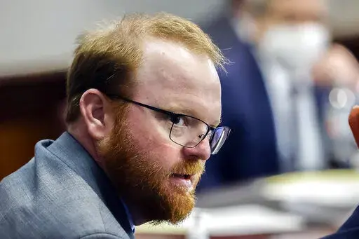 Travis McMichael is shown during the sentencing of he and his father Greg McMichael and neighbor, William "Roddie" Bryan in the Glynn County Courthouse, Friday, Jan. 7, 2022, in Brunswick, Ga. The man who fatally shot Ahmaud Arbery and his father have reached a plea deal that could avoid their trial on federal hate crime charges. Arbery's parents denounced the deal as a betrayal, and called on the judge to reject it. Court documents filed late Sunday, Jan. 30, 2022, by prosecutors for the U.S. J