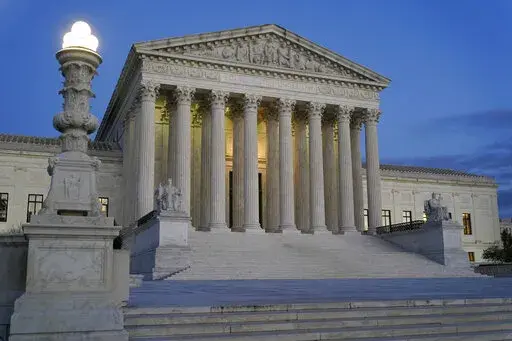 Light illuminates part of the Supreme Court building at dusk on Capitol Hill in Washington, Nov. 16, 2022. The Supreme Court has agreed to hear an appeal arising from a murder-for-hire ordered by the onetime leader of a violent international crime ring. The justices said Tuesday they will review the case of Adam Samia, who is serving a life sentence for killing a real estate broker in the Philippines. (AP Photo/Patrick Semansky, File)