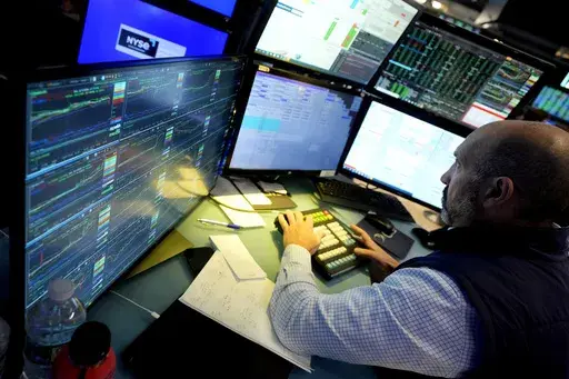 Specialist James Denaro works at his post on the floor of the New York Stock Exchange on June 12, 2024. Global shares were mixed on Friday, June 14, 2024, after Wall Street touched fresh records, with benchmarks pushed higher by the frenzy over artificial intelligence technology. (AP Photo/Richard Drew, File)