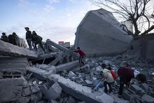 Palestinians look at a mosque destroyed in an Israeli strike in Rafah, Gaza Strip, Wednesday, Jan. 24, 2024. Efforts to reach a new cease-fire between Israel and Hamas appear to be gaining steam. Any deal would have to include a pause in fighting, an exchange of hostages held by Hamas for Palestinian prisoners held by Israel and large quantities of desperately needed humanitarian assistance for the war-battered Gaza Strip. But finding a formula acceptable to both sides has been elusive. The gaps