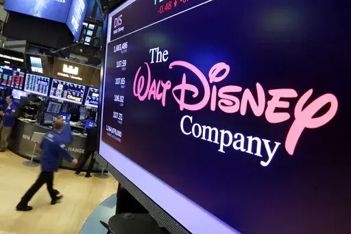 In this Aug. 8, 2017, file photo, The Walt Disney Co. logo appears on a screen above the floor of the New York Stock Exchange. Disney is working on sequels for its “Toy Story,” “Frozen” and “Zootopia” franchises as the company concentrates more on brands that have continued to perform well. The Walt Disney Co. is working on a “strategic transformation,” announced by CEO Bob Iger on Wednesday, Feb. 8 2023. (AP Photo/Richard Drew, File)