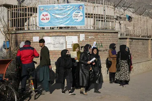Afghan women students stand outside the Kabul University in Kabul, Afghanistan, on Dec. 21, 2022. The United Nations' human rights chief on Tuesday Dec. 27, 2022 decried increasing restrictions on women's rights in Afghanistan, urging the country's Taliban rulers to reverse them immediately. He pointed to “terrible consequences” of a decision to bar women from working for non-governmental organizations. (AP Photo/Ebrahim Noroozi, File)