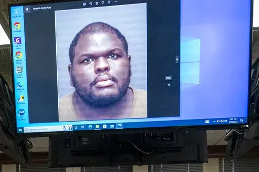 An image of Ronald Ray Mosley II, 25, is displayed on a monitor during a press conference, Friday afternoon, Jan. 20, 2023, related to the ongoing investigation of a shooting at the West Side Walmart in Evansville, Ind. Police identified the shooter as Mosleym a former Walmart employee who was charged with assaulting four people in the store last year. (MaCabe Brown/Evansville Courier & Press via AP)