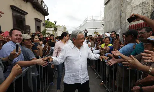 Mexican President-elect Andres Manuel Lopez Obrador greets supporters as he kicks off a nationwide tour after his election in Mazatlan, Mexico, Sept. 16, 2018. (AP Photo/Eduardo Verdugo, File)