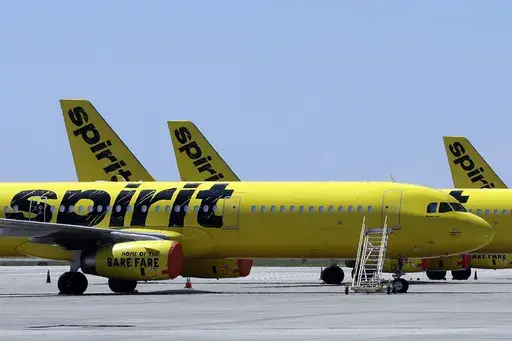 A line of Spirit Airlines jets sit on the tarmac at Orlando International Airport on May 20, 2020, in Orlando, Fla. A 6-year-old boy who left on a flight for the Christmas holiday to visit his grandmother was put on the wrong plane. When the grandmother, up on Thursday, Dec. 21, 2023 at the airport in Fort Myers to greet her grandson who was flying for the first time from Philadelphia, she was told he wasn’t on the Spirit Airlines flight. (AP Photo/Chris O'Meara, File)
