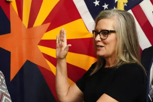 The new Arizona Democratic Gov. Katie Hobbs takes the oath of office in a ceremony at the state Capitol in Phoenix, Monday, Jan. 2, 2023. (AP Photo/Ross D. Franklin, Pool)