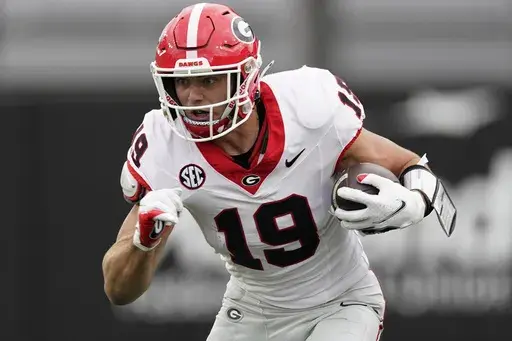Georgia tight end Brock Bowers (19) runs the ball after a catch against Vanderbilt in the first half of an NCAA college football game Saturday, Oct. 14, 2023, in Nashville, Tenn. Bowers has been selected to The Associated Press midseason All-America team, Wednesday, Oct. 18, 2023.(AP Photo/George Walker IV, File)