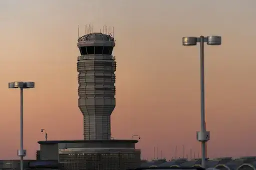 The air traffic control tower at Ronald Reagan Washington National Airport is seen at sunset, Saturday, Feb. 1, 2025, in Arlington, Va.. (AP Photo/Jose Luis Magana, file)