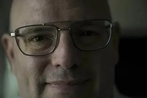 Harel Hershtik pose for a photograph at his labs in Rehovot, Israel, Wednesday, May 11, 2022. When he was 20 years old,  Hershtik planned and executed a murder. Today, he is the brains behind an Israeli health-tech startup, poised to make millions of dollars with the backing of prominent public figures and deep-pocketed investors. (AP Photo/Ariel Schalit)