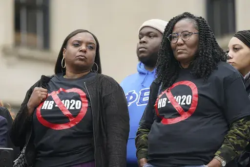 People voicing their opposition to Mississippi House Bill 1020 wear protest t-shirts as they gathered on the steps of the Mississippi Capitol in Jackson, Jan. 31, 2023. A federal judge will consider arguments over racial discrimination, public safety and local democracy as he decides whether to block appointments to a new state-run court in part of Mississippi's majority-Black capital city set to be created on Monday, Jan. 1, 2024. (AP Photo/Rogelio V. Solis, File)