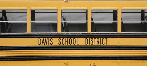 A Davis School District bus sits at the Bus Farm in Farmington, Utah, in this undated photo. A Black woman hired by the northern Utah school district to investigate racial harassment complaints a year after a 10-year-old Black student died by suicide says that she, too, experienced discrimination from district officials. Joscelin Thomas, a former coordinator in the Davis School District's equal opportunity office, alleges in a federal lawsuit that district administrators treated her “as if she