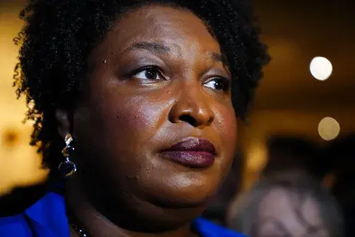 Georgia gubernatorial Democratic candidate Stacey Abrams talks to the media after qualifying for the 2022 election on Tuesday, March 8, 2022, in Atlanta. When she ended her first bid to become Georgia governor in 2018, Abrams announced plans to sue over the way the state’s elections were managed. More than three years later, as she makes another run at the governor’s mansion, the lawsuit filed in Nov. 2018 by Abrams' Fair Fight Action organization is finally going to trial on Monday, April 1