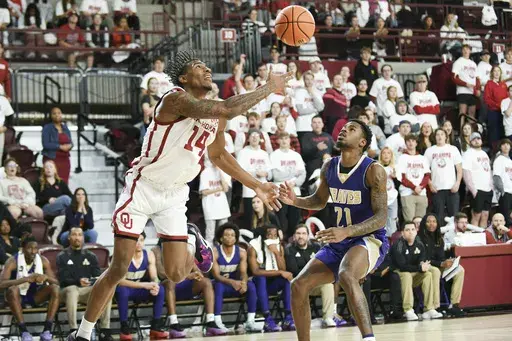 Oklahoma forward Jalon Moore (14) shoots over Alcorn State guard Kameron Foman (21) during the first half of an NCAA college basketball game, Saturday, Dec. 7, 2024, in Norman, Okla. (AP Photo/Kyle Phillips)