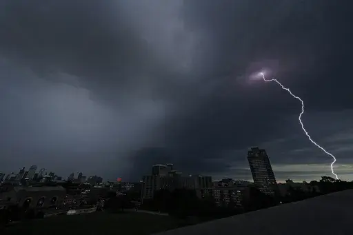 Lightning strikes in the distance as a thunderstorm passes over downtown Kansas City, Mo., July 30, 2023. Tens of millions of Americans stretching from Lincoln, Neb., to Baltimore could face strong thunderstorms Monday night, April 15, 2024, through Wednesday, April 17, with tornadoes possible in some states. (AP Photo/Charlie Riedel, File)