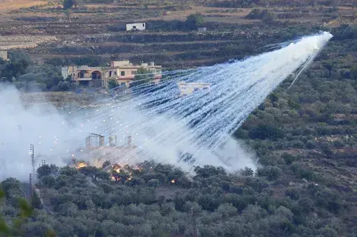 A shell that appears to be white phosphorus from Israeli artillery explodes over a house in al-Bustan, a Lebanese village along the border with Israel, on Oct. 15, 2023. A global human rights group claimed in a report published Wednesday, June 5, 204, that Israel has used white phosphorus incendiary shells on residential buildings in at least five towns and villages in conflict-hit southern Lebanon, possibly harming civilians and violating international law. (AP Photo/Hussein Malla, File)