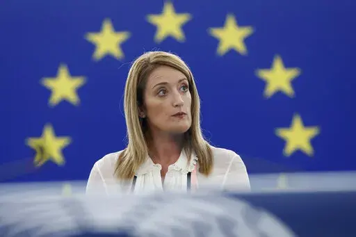 European Parliament President Roberta Metsola delivers her speech during a special session on lobbying Monday, Dec. 12, 2022 in Strasbourg, eastern France. Four people have been charged with being part of a criminal group, money laundering and corruption in connection with an investigation into suspected influence peddling by a Persian Gulf country at the European Union's parliament. (AP Photo/Jean-Francois Badias)