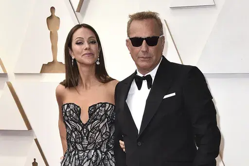Christine Baumgartner, left, and Kevin Costner arrive at the Oscars, March 27, 2022, at the Dolby Theatre in Los Angeles. Costner and Baumgartner, his wife of nearly 19 years, are divorcing, a representative for the actor said Tuesday, May 2, 2023. (Photo by Jordan Strauss/Invision/AP, File)
