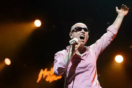 Irish singer Sinead O'Connor performs on the Stravinski Hall stage at the 49th Montreux Jazz Festival, in Montreux, Switzerland on July 4, 2015. O’Connor, the gifted Irish singer-songwriter who became a superstar in her mid-20s but was known as much for her private struggles and provocative actions as for her fierce and expressive music, has died at 56. The singer's family issued a statement reported Wednesday by the BBC and RTE. (Jean-Christophe Bott/Keystone via AP, File)