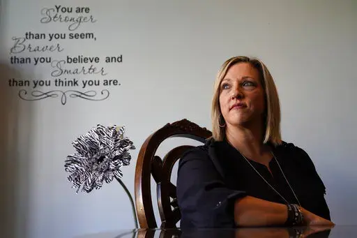 Tina Meier, founder of the Megan Meier Foundation, poses for a photo in the foundation's office Wednesday, Dec. 8, 2021, in St. Charles, Mo. Meier's daughter, Megan, committed suicide in 2007 at the age of 13 after being harassed by a "friend" on MySpace who later turned out to be the mother of a classmate who was using the fake account to bully the unsuspecting teen. (AP Photo/Jeff Roberson)