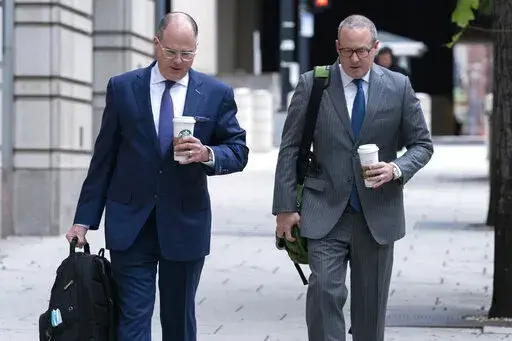 Attorneys of Oath Keepers leader Stewart Rhodes, Phillip Linder, left, and James Lee Bright, arrive at the Federal Courthouse during the Rhodes trial in Washington, Tuesday, Oct. 4, 2022. The founder of the Oath Keepers extremist group and four associates planned an "armed rebellion" to keep President Donald Trump in power, a federal prosecutor contended Monday, as the most serious case yet went to trial in the Jan. 6, 2021, attack on the U.S. Capitol. ( AP Photo/Jose Luis Magana)