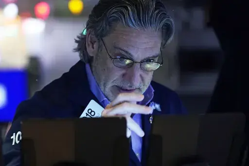 Trader John Romolo works on the floor of the New York Stock Exchange, Wednesday, Dec. 18, 2024. (AP Photo/Richard Drew)